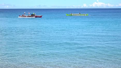 Wide-shot-of-two-fishing-boats-crossing-paths-on-the-ocean