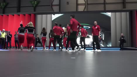 Geneva,-Switzerland---March-12th,-2019:-Low-Wide-angle-shot-of-a-group-of-young-dancers-finishing-their-dance-at-the-Honda-booth,-Autosalon-Geneva-Motor-Show-2019,-Switzerland