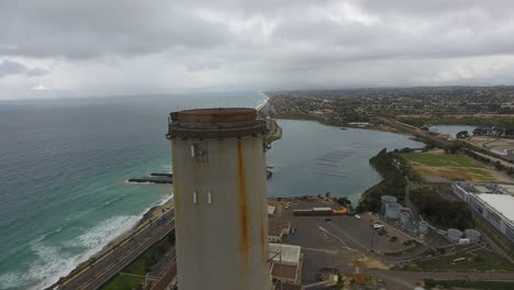 Cinematic-drone-shot-of-smokestack-at-the-NRG-Encina-Power-Plant-on-the-coast-of-Carlsbad,-CA