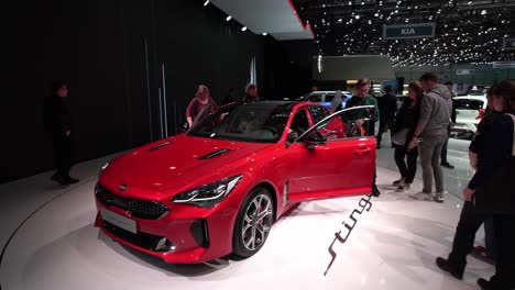 Geneva,-Switzerland---March-12th,-2019:-wide-slow-motion-shot,-KIA-Stinger,-KIA-booth,-Autosalon-Geneva-Motor-Show-2019