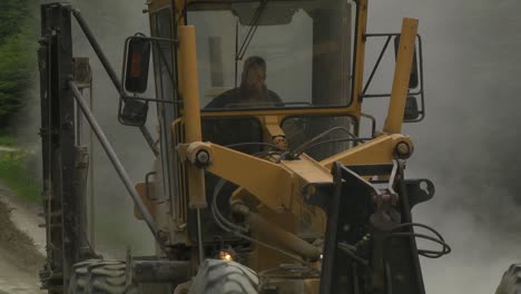 Follow-Shot-Of-Yellow-Grader-Leveling-Soil-On-Road