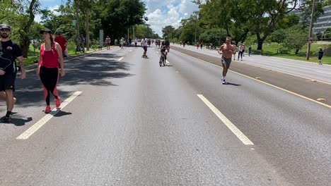 Multiple-people-using-various-forms-of-exercising-on-beautiful-sunny-day