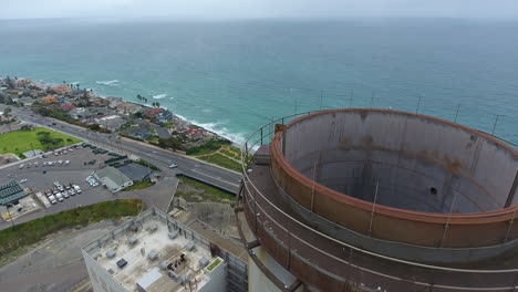 Cinematic-drone-shot-of-smokestack-at-the-NRG-Encina-Power-Plant-on-the-coast-of-Carlsbad,-CA