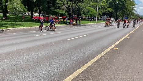 Adults-leisurely-pedal-their-bicycles-enjoying-the-warmth-of-the-sun