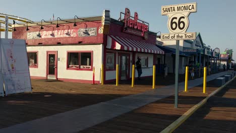 Panning-shot-of-people-walking-at-Santa-Monica-pier-in-Los-Angeles-after-reopening