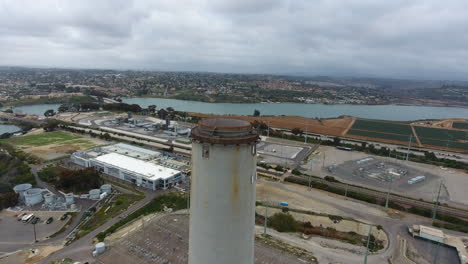 Cinematic-drone-shot-of-smokestack-at-the-NRG-Encina-Power-Plant-on-the-coast-of-Carlsbad,-CA