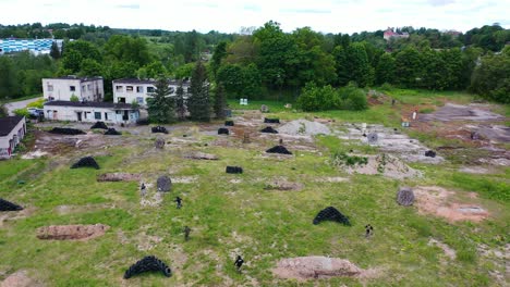 Flying-above-closed-airsoft-war-game-field,-team-attack-and-take-position