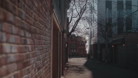 Empty-Side-Street-With-Brick-Wall-With-Steam-Coming-Out-In-The-Background-During-Lockdown