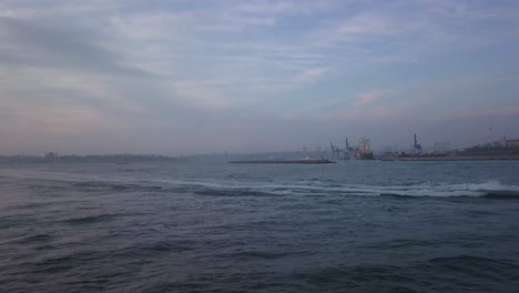 Aerial-View-of-Ferry-Ship-Sailing-Into-Bosporus-Strait-on-Sunset-by-Rampart-and-Lighthouse-on-Marmara-Sea,-Istanbul-Turkey