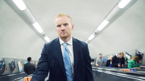 BusinessMan-Standing---Riding-Escalator-on-Morning-Commute---High-Angle