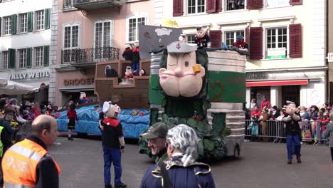 Solothurn,-Switzerland---March-03th,-2019:-A-carnivals-club-with-funny-masks-looking-like-Pop-Eye-on-their-huge-vehicle