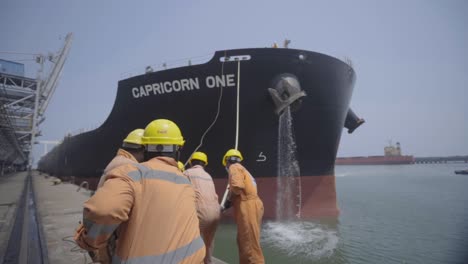 Dockers-Pulling-Mooring-Rope-Of-A-Large-Container-Ship-Arriving-At-The-Port