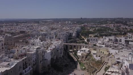 Drone-shot-of-the-old-bridge-of-Polignano-a-Mare,-Italy