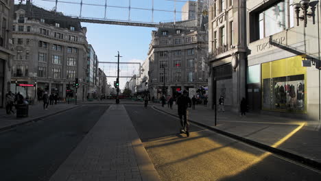 London-in-Covid-19-Coronavirus-lockdown-with-quiet-empty-roads-at-Oxford-Street-and-Oxford-Circus,-with-closed-shops-shut-down-at-the-popular-shopping-high-street-in-the-pandemic-in-England,-Europe