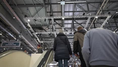 Geneva,-Switzerland--:-Driving-up-the-escalator-to-the-exit-of-the-Exhibition-Autosalon-Geneva-Motor-Show-Switzerland