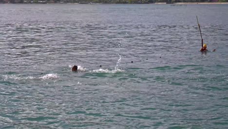 Two-young-boys-compete-against-each-other-in-the-schools-annual-outdoor-swimming-challenge-in-DInagat,-Philippines