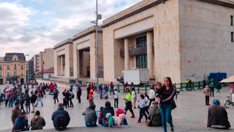 A-woman-is-carrying-her-small-son-and-walking-on-the-Historic-Plaza-of-Bogotá,-Colombia