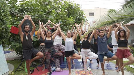 Group-Of-People-Posing-In-Home's-Yard-Breathing-And-Stretching,-Lima,-Peru