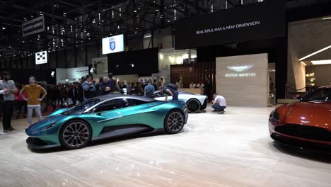 Geneva,-Switzerland---March-12th,-2019:-high-angle-wide-panning-shot-of-the-Aston-Martin-booth-at-Autosalon-Geneva-Motor-Show-2019