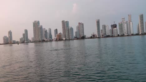 Two-dolphins-swimming-together-are-seen-from-a-boat-on-the-ocean-of-Cartagena-de-Indias,-Colombia