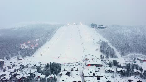 Aerial-view-away-from-the-Levi-village-and-ski-slopes,-winter-in-Lapland---pull-back,-drone-shot