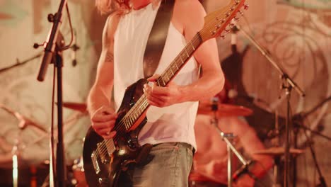 Adult-Caucasian-Male-Playing-Guitar-At-The-Black-Earth-Park-In-Nyoiseau