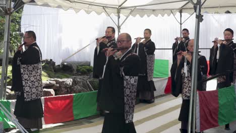 Japanese-worship-singers,-sing-on-the-flute-and-getting-prepared-for-the-traditional-commemoration-ceremony