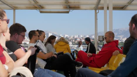 People-on-the-ferry-rack-focus-to-split-city