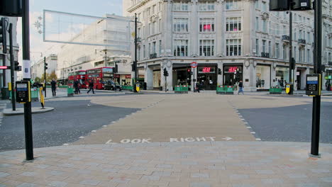 London-in-Covid-19-Coronavirus-lockdown-with-quiet-empty-roads-at-Oxford-Street-and-Oxford-Circus,-with-closed-shops-shut-down-at-the-popular-shopping-high-street-in-the-pandemic-in-England,-Europe