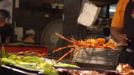 Seafood-Restaurant-at-Night-Market,-Thailand,-Crabs-on-Display-and-Barbecue