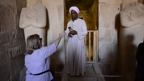 Egyptian-takes-a-selfie-for-a-tourist-in-Queen-Hatshepsut-Temple-at-The-Valley-of-the-Kings,-Egypt