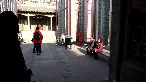 Gubei-Water-Town-people-hanging-at-a-textile-patio-admiring-hanging-textile