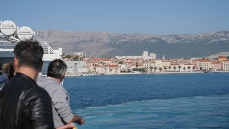 People-on-the-ferry-rack-focus-to-Split-city