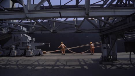 Slow-Motion-Of-Dockers-Pulling-Anchor-Mooring-Line-Of-A-Huge-Ship-At-The-Port