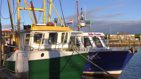 Nautical-Vessels-up-and-down-moored-on-Wadden-Island-Dock---Medium-static-shot