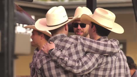 Young-men-in-white-cowboy-hats-assembled-at-Memorial-day-Parade---Long-close-up-shot