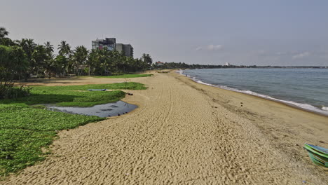 Negombo-Sri-Lanka-Aerial-v10-low-drone-fly-along-long-stretches-of-golden-sand-Browns-beach-capturing-sea-view-hotels-and-residential-houses-in-Wellaweediya-area---Shot-with-Mavic-3-Cine---April-2023