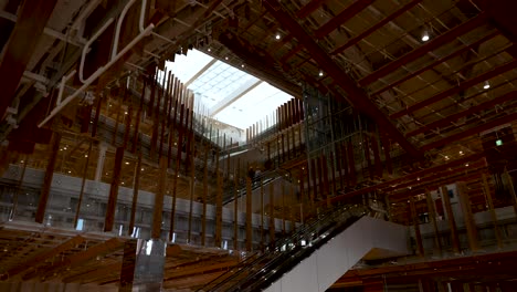 Visitors-on-escalators-inside-the-Toyama-Glass-Art-Museum,-Japan