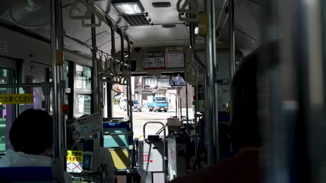 Some-locals-on-the-bus-are-waiting-for-departure-in-Kazanawa,-Japan