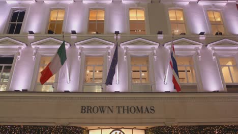 Flags-On-The-Brown-Thomas-Department-Store-Building-At-Night-In-Dublin,-Ireland