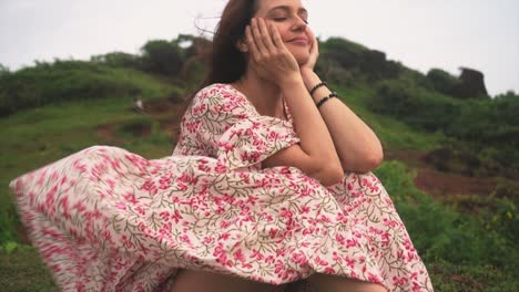 A-detailed-shot-focuses-on-the-intricate-floral-pattern-of-an-Indian-woman's-dress-as-she-immerses-herself-in-reading-a-book-in-Panaji,-Goa,-India-on-31-08-2023