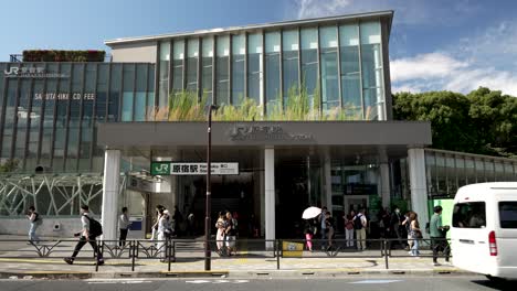 Main-Entrance-At-JR-Harajuku-Station-On-Sunny-Day-With-People-Walking-Past