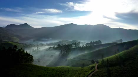 Aerial-drone-shot-of-the-sun-shining-on-the-hills-and-mountains-visible