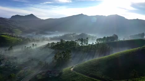 Aerial-drone-shot-of-drone-Camaro-moving-forward-and-sun-rays-shining-over-the-hills