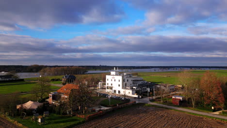 Dramatic-drone-establishing-of-Hertog-Jan-Arcen-beer-brewery-next-to-Meuse