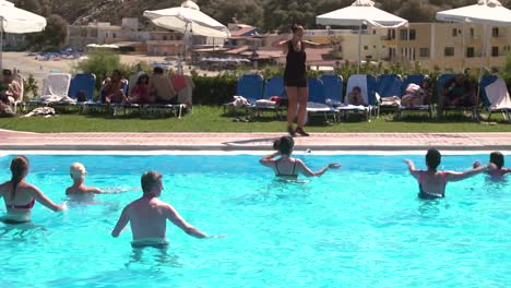 Group-of-People-in-a-Aquatic-Fitness-Class-with-the-Trainer,-Slow-Motion