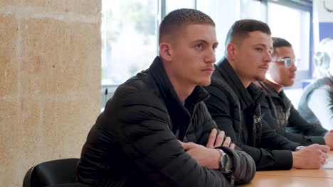 Young-roofworker-students-sitting-in-classroom-paying-attention-for-a-training-class