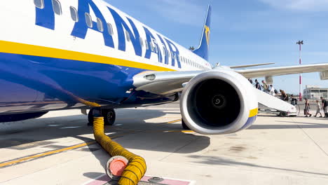 Parked-airplane-with-ground-support-equipment-attached---Ryanair,-cheap-air-line