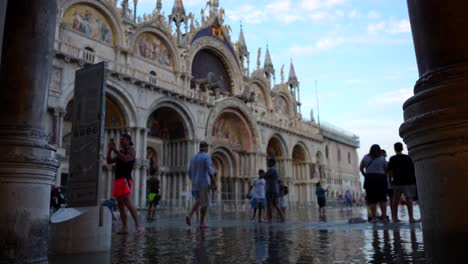 Tourists-capture-exceptional-high-tide-in-flooded-Piazza-San-Marco,-Venice