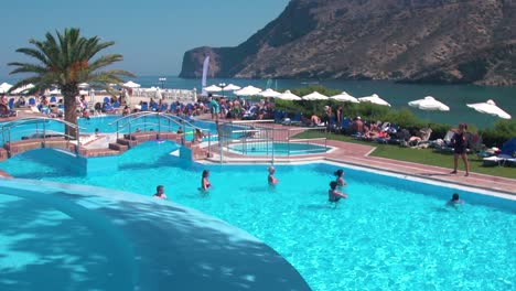 Group-of-People-Having-a-Aquatic-Fitness-Class-in-a-Resort-Pool,-Slow-Motion